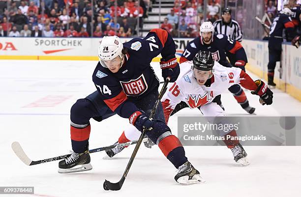 Oshie of Team USA stickhandles the puck with Jonathan Toews of Team Canada chasing during the World Cup of Hockey 2016 at Air Canada Centre on...