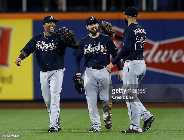 Emilio Bonifacio, Ender Inciarte and Nick Markakis of the Atlanta Braves celebrate the 5-4 win over the New York Mets on September 20, 2016 at Citi...