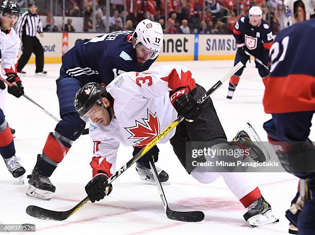Patrice Bergeron of Team Canada battles for the puck with Ryan Kesler of Team USA during the World Cup of Hockey 2016 at Air Canada Centre on...