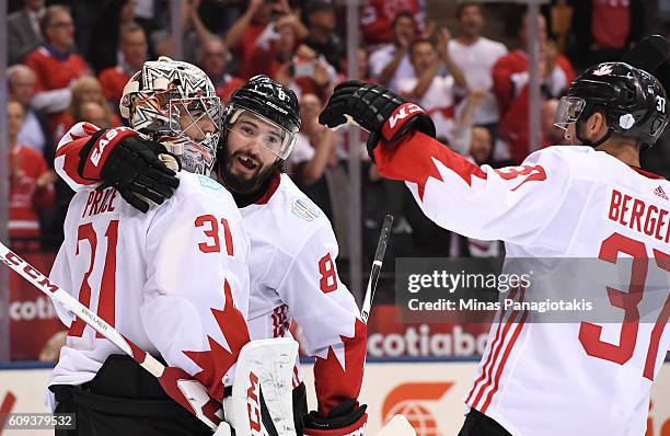 Drew Doughty and Patrice Bergeron celebrate with Carey Price of Team Canada after a 4-2 win over Team USA during the World Cup of Hockey 2016 at Air...