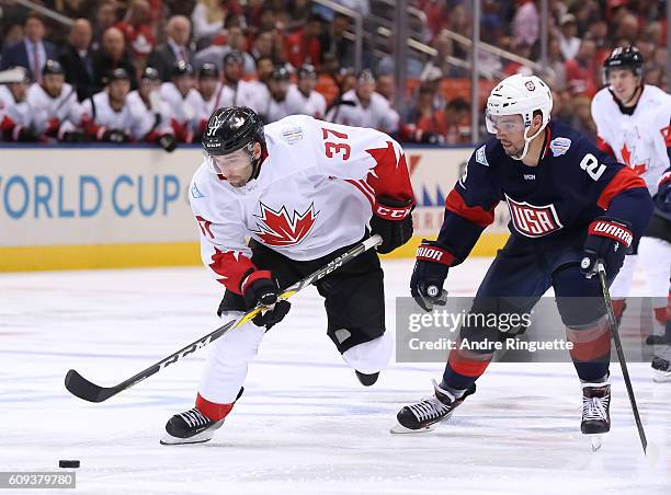 Patrice Bergeron of Team Canada charges up ice with Matt Niskanen of Team USA chasing during the World Cup of Hockey 2016 at Air Canada Centre on...