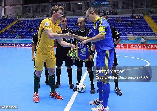 Greg Giovenali of Australia and Dmytro Bondar of Ukraine shake hands at center court prior to Group D match play between Australia and Ukraine in the...