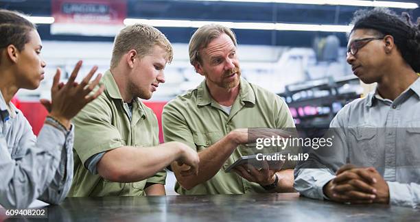 instuctor and students in technical training school - mechanic tablet stock pictures, royalty-free photos & images