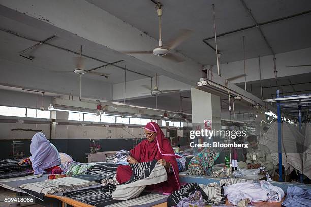 Workers inspects fabric ahead of stitching at D.L. Nash Ltd., a textile manufacturer in Karachi, Pakistan, on Saturday, Sept. 10, 2016. Despite a...