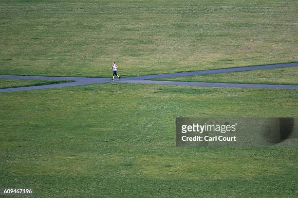 Woman jogs through Greenwich Park on September 21, 2016 in London, England. Today marks final day of summer as the autumn equinox arrives on...