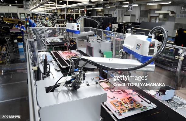 Automatic machines assemble LCD 4K televisions on an assembly line at the Utsunomiya Plant of Japan's electronics giant Panasonic in Utsunomiya, 100...