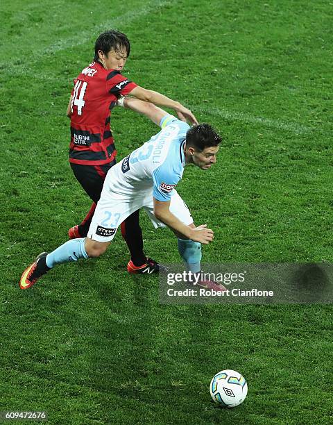 Bruno Fornaroli of Melbourne City is challenged by Jumpei Kusukami of the Wanderers during the FFA Cup Quarter Final between Melbourne City and...