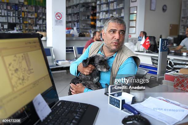 Delivery man Murat Ozgen, is seen with his dog "zeytin" on his motorbike in Istanbul, Turkey on September 10, 2016. Ozgen goes to work with his dog...