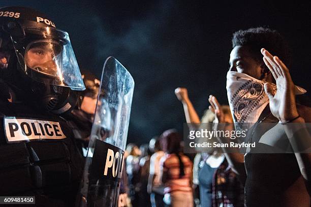 Police officers face off with protesters on the I-85 during protests in the early hours of September 21, 2016 in Charlotte, North Carolina. The...