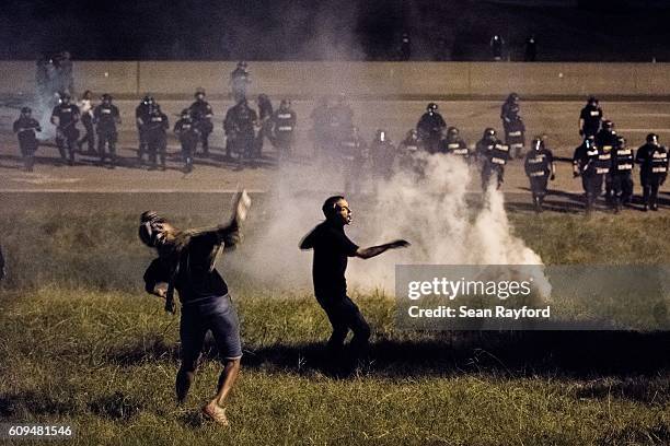 Protestors throw objects at police officers on the I-85 d during protests in the early hours of September 21, 2016 in Charlotte, North Carolina. The...