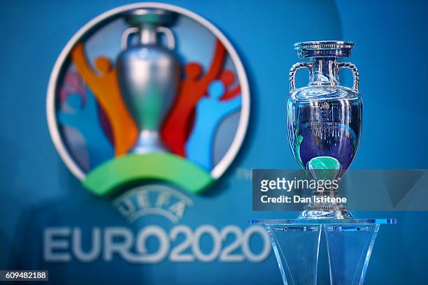 The UEFA European Championship trophy is displayed next to the logo for the UEFA EURO 2020 tournament during the UEFA EURO 2020 launch event for...