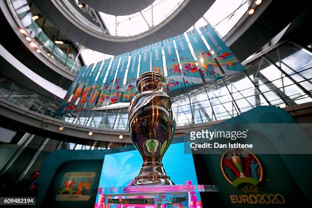 The UEFA European Championship trophy is displayed next to the logo for the UEFA EURO 2020 tournament and the individual city logos during the UEFA...