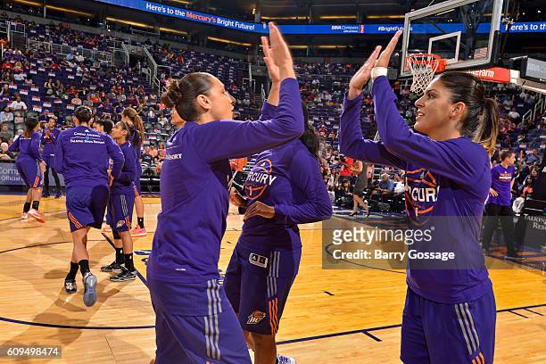 Diana Taurasi and Nirra Fields of the Phoenix Mercury high five as they run out before the game against the Seattle Storm on September 15, 2016 at...
