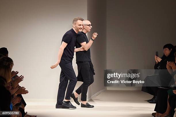 Designers Tommaso Aquilano and Roberto Rimondi acknowledge the applause of the audience after the Fay show during Milan Fashion Week Spring/Summer...