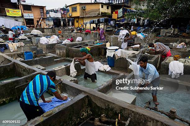 Men wash clothes at an open-air laundromat near Cuffe Parade in South Mumbai.