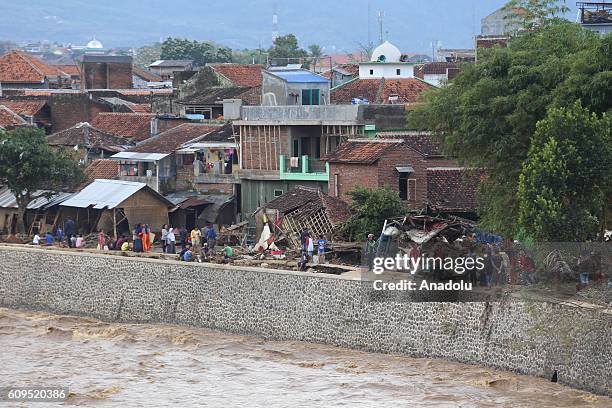 Villagers work at the flash-flood devastated area in Garut of West Java, Indonesia, 21 September 2016. At least 16 people have died due to floods and...