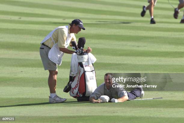 Jerry Kelly lays on the fairway after nearly holing out during the final round of the Reno-Tahoe Open at the Montreux Golf Club in Reno, Nevada....