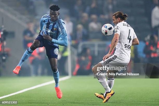 Michael Olunga of Djurgardens IF and Nils-Eric Johansson of AIK fight for the ball during the Allsvenskan match between Djurgardens IF and AIK at...