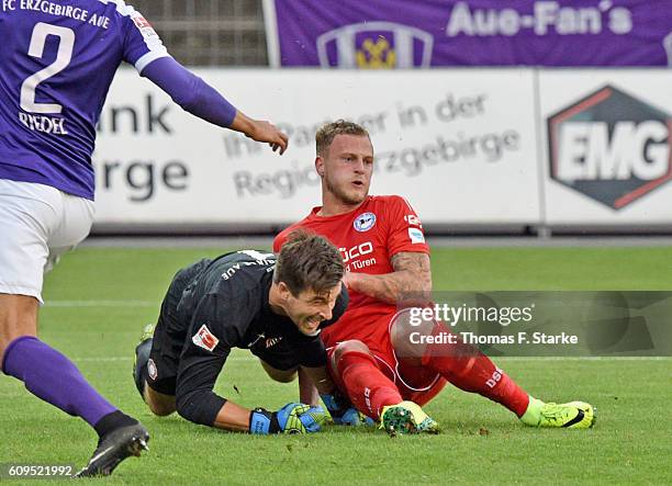Christoph Hemlein of Bielefeld clashes with goalkeeper Martin Maennel during the Second Bundesliga match between FC Erzgebirge Aue and DSC Arminia...
