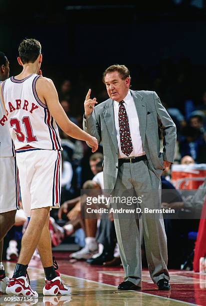 Head coach Bill Fitch of the Los Angeles Clippers talks to Brent Barry during the game in 1995 at the Los Angeles Memorial Sports Arena in Los...