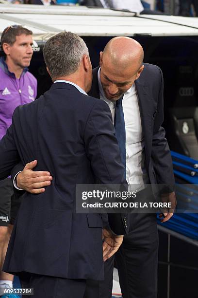 Villarreal's coach Fran Escriba Segura greets Real Madrid's French coach Zinedine Zidane before the Spanish league football match Real Madrid CF vs...