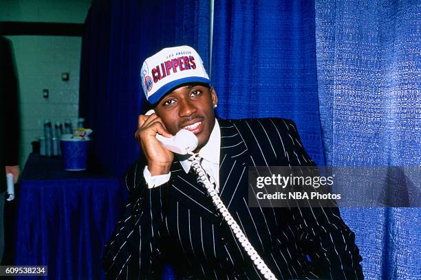 Lorenzen Wright talks on the phone after he was drafted by the Los Angeles Clippers on June 26, 1996 in East Rutherford, New Jersey. NOTE TO USER:...