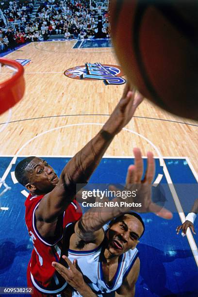 Lorenzen Wright of the Los Angeles Clippers goes to the basket against Howard Eisley of the Utah Jazz in Circa 1997 at the Delta Center in Salt Lake...