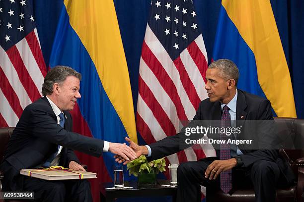 President of Colombia Juan Manuel Santos shakes hands with U.S. President Barack Obama during a bilateral meeting at the Lotte New York Palace Hotel,...