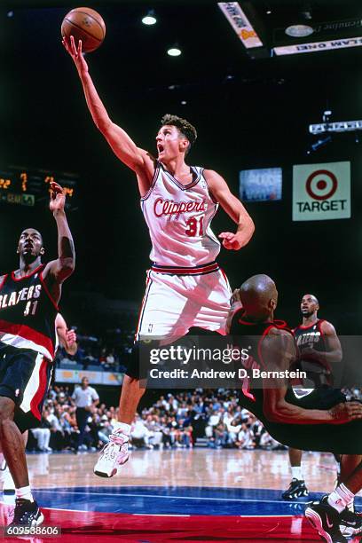 Brent Barry of the Los Angeles Clippers goes to the basket against the Portland Trail Blazers in Circa 1998 at the Los Angeles Memorial Sports Arena...