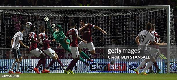 Manchester United's English midfielder Michael Carrick scores his team's first goal during the English League Cup third round football match between...