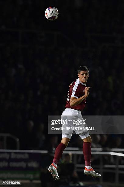 Northampton's English striker Alex Revell jumps for the ball during the English League Cup third round football match between Northampton Town and...