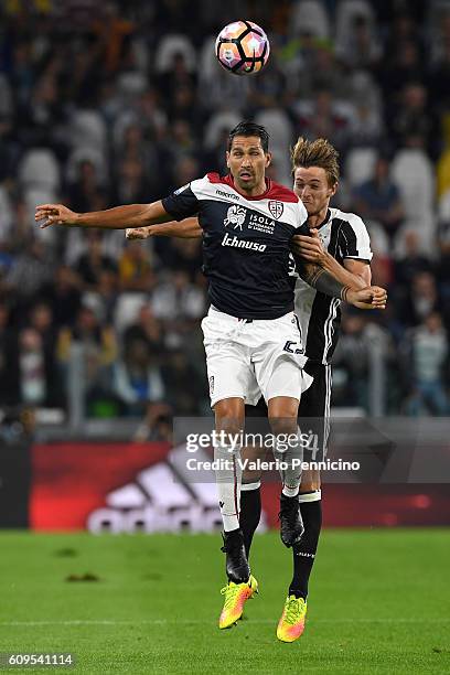 Daniele Rugani of Juventus FC goes up with Marco Borriello of Cagliari Calcio during the Serie A match between Juventus FC and Cagliari Calcio at...