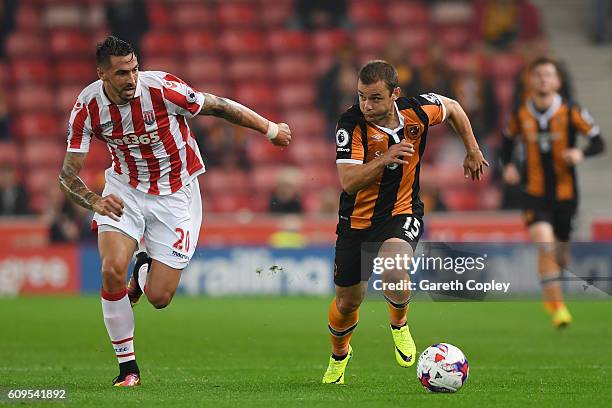 Shaun Maloney of Hull City and Geoff Cameron of Stoke City in action during the EFL Cup Third Round match between Stoke City and Hull City at the...