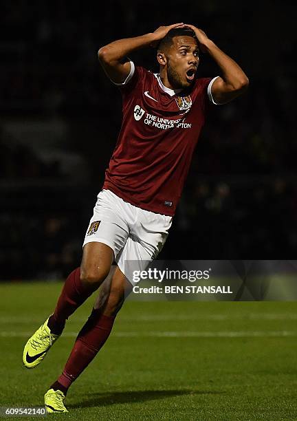 Northampton's Dutch midfielder Kenji Gorre reacts after missing a shot on goal during the English League Cup third round football match between...