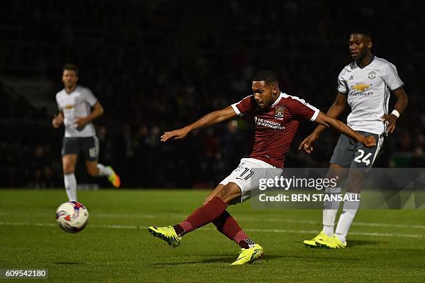 Northampton's Dutch midfielder Kenji Gorre attempts a shot on goal during the English League Cup third round football match between Northampton Town...