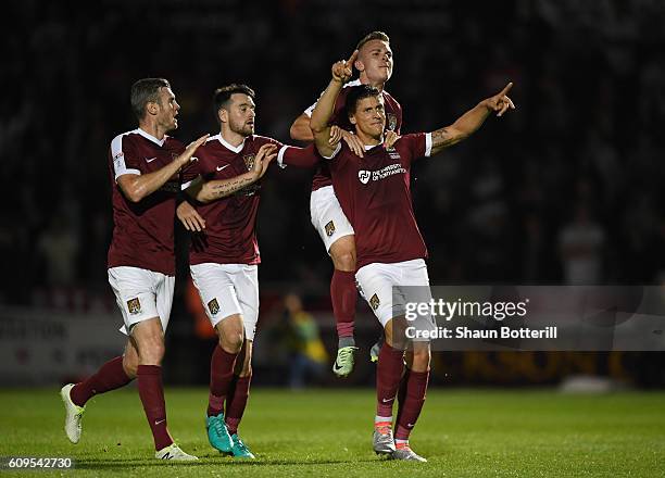 Alex Revell of Northampton Town celebrates scoring his sides first goal with team mates during the EFL Cup Third Round match between Northampton Town...