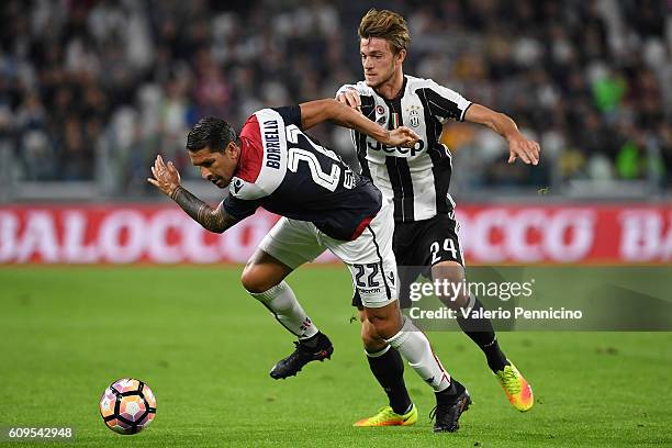 Daniele Rugani of Juventus FC tackles Marco Borriello of Cagliari Calcio during the Serie A match between Juventus FC and Cagliari Calcio at Juventus...