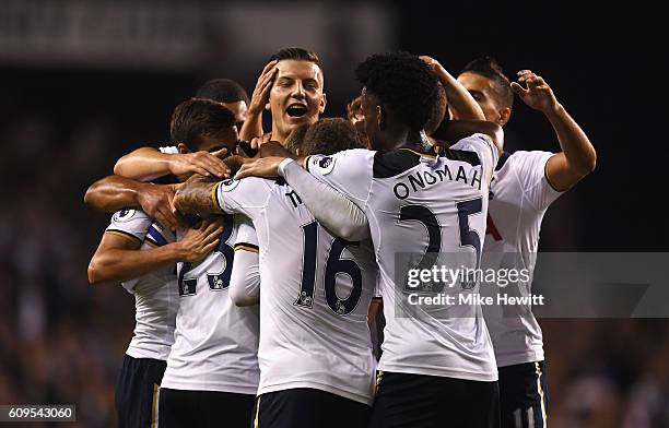 Christian Eriksen of Tottenham Hotspur celebrates scoring his sides first goal with team mates during the EFL Cup Third Round match between Tottenham...