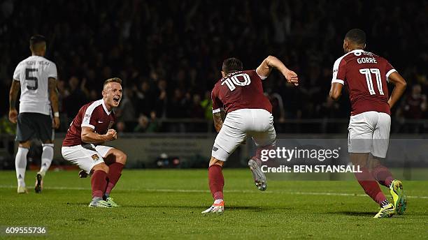 Northampton's English striker Sam Hoskins and Northampton's Dutch midfielder Kenji Gorre reacts as Northampton's English striker Alex Revell...