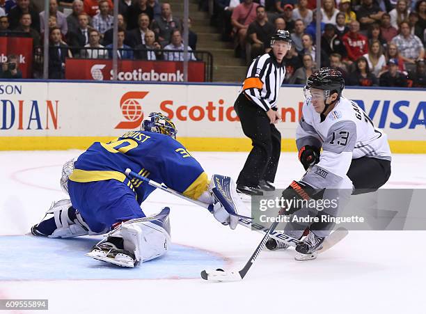 Johnny Gaudreau of Team North America stickhandles the puck around Henrik Lundqvist of Team Sweden to score a first period goal during the World Cup...