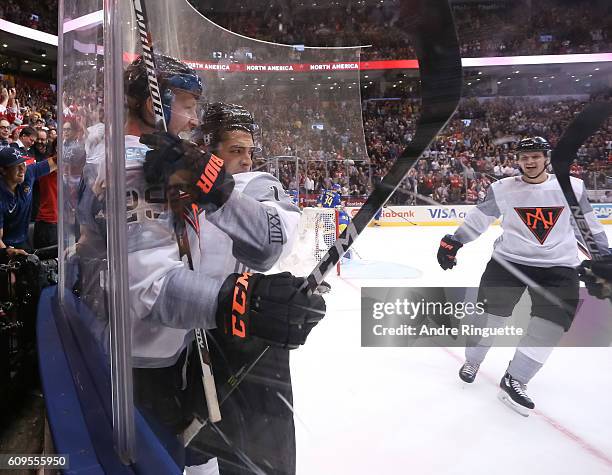 Johnny Gaudreau celebrates with Nathan MacKinnon of Team North America after scoring a first period goal on Team Sweden during the World Cup of...