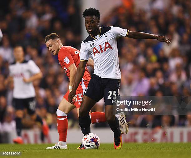 Joshua Onomah of Tottenaham Hotspur in action with Mark Byrne of Gillingham during the EFL Cup Third Round match between Tottenham Hotspur and...