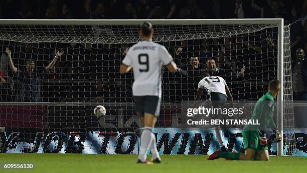 Manchester United's English striker Marcus Rashford scores his team's thrid goal during the English League Cup third round football match between...