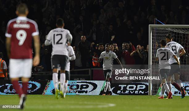 Manchester United's English striker Marcus Rashford celebrates scoring his team's third goal during the English League Cup third round football match...
