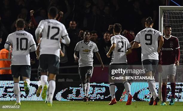 Manchester United's English striker Marcus Rashford celebrates scoring his team's third goal during the English League Cup third round football match...