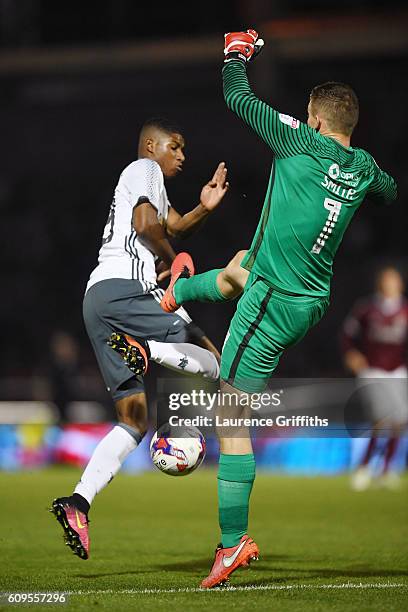 Adam Smith of Northampton Town makes a mistake as Marcus Rashford of Manchester United capitalises to score his sides third goal during the EFL Cup...