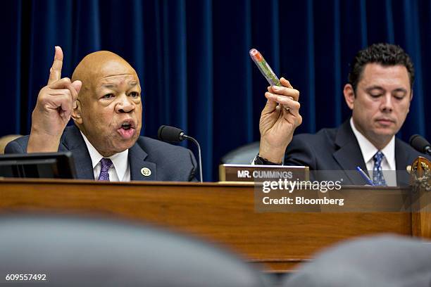 Representative Elijah Cummings, a Democrat from Maryland, left, holds Mylan NV EpiPen medication while making an opening statement next to...