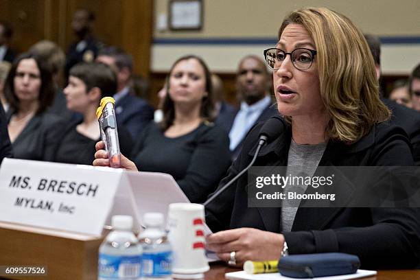 Heather Bresch, chief executive officer of Mylan NV, holds up Mylan EpiPen medication while speaking during a House Oversight and Government Reform...