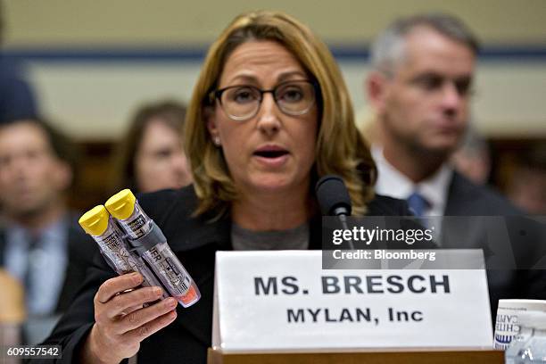 Heather Bresch, chief executive officer of Mylan NV, holds up Mylan EpiPen medication while speaking during a House Oversight and Government Reform...