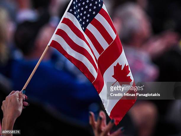 Fan waves a Canadian and United states flag during the World Cup of Hockey 2016 between Team Sweden and Team North America at Air Canada Centre on...